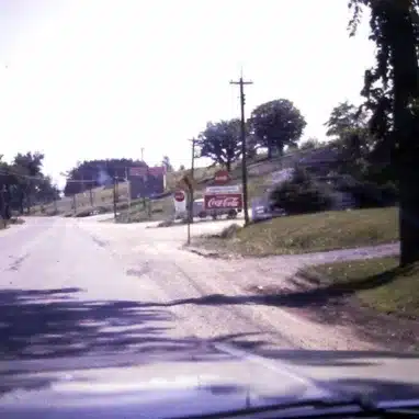 A car driving down a road with a sign in Orleans.