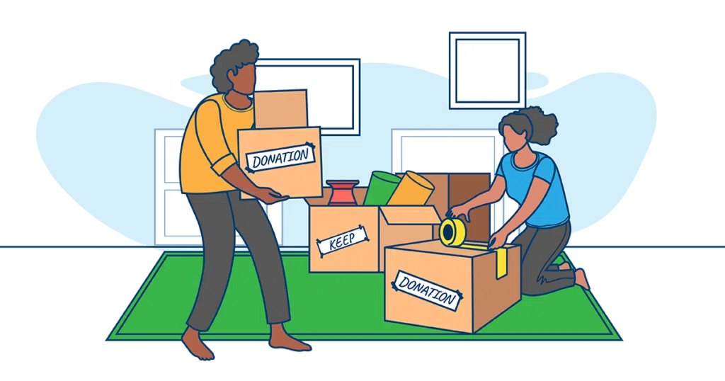 Efficient Downsizing: Sorting Items into Keep and Donation Boxes Before a Move Two people organizing items into Keep and Donation boxes during a downsizing process for a home move.